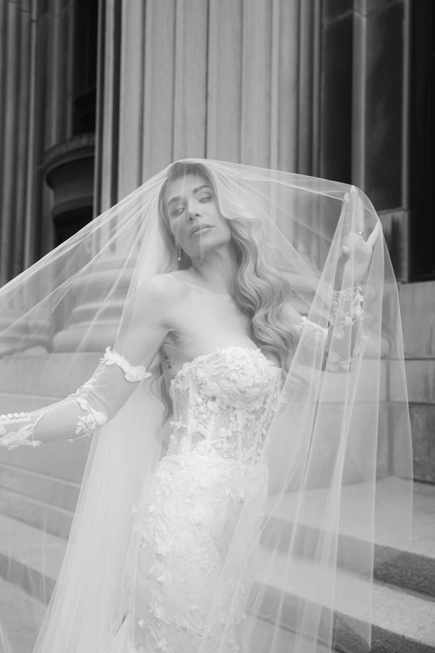 Bride in a strapless wedding gown with a long veil.